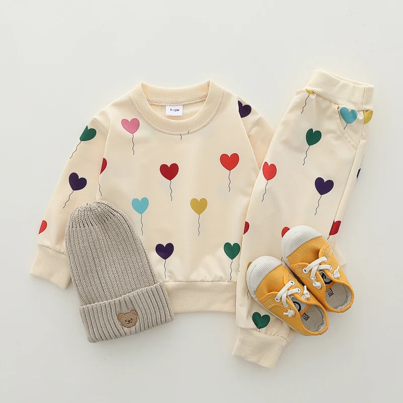 Heart Print Baby Outfit Set with Beige Long Sleeve Crewneck Top and Matching Cuffed Pants, Two-Piece Casual Clothing for Spring and Fall, 3-24M